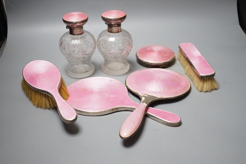 A George silver and enamel mounted glass part dressing table set, by Henry Clifford Davis and a similar American hand mirror.